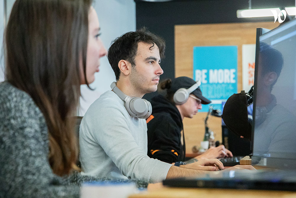 8SEC team working at their desks in the studio